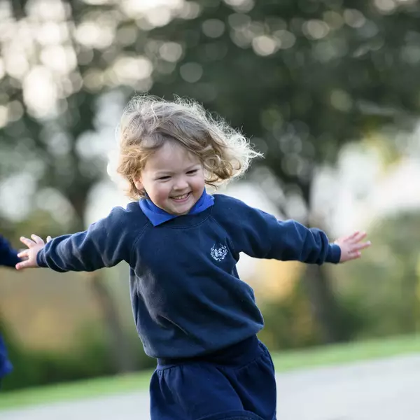 Nursery girl running outside Prep School